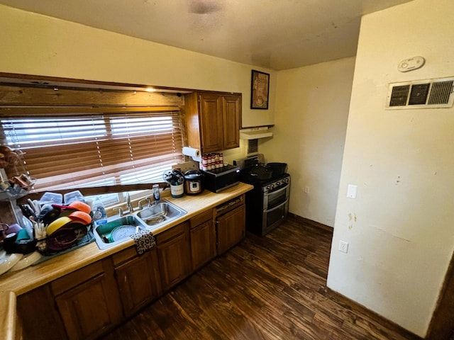 kitchen with sink, dark wood-type flooring, and range with gas cooktop