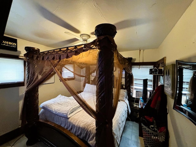 bedroom with multiple windows, ceiling fan, and cooling unit