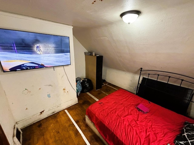 bedroom with vaulted ceiling and dark hardwood / wood-style floors