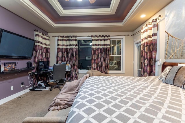 bedroom with carpet flooring and a raised ceiling