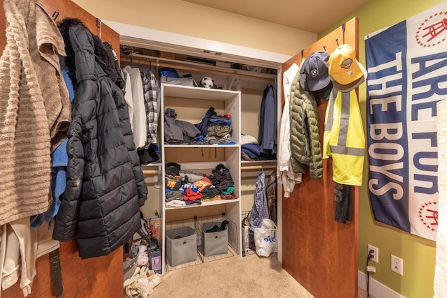 walk in closet with carpet flooring