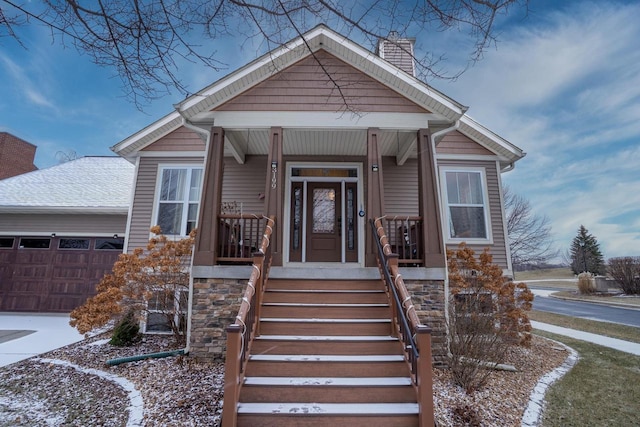 bungalow with a porch and a garage