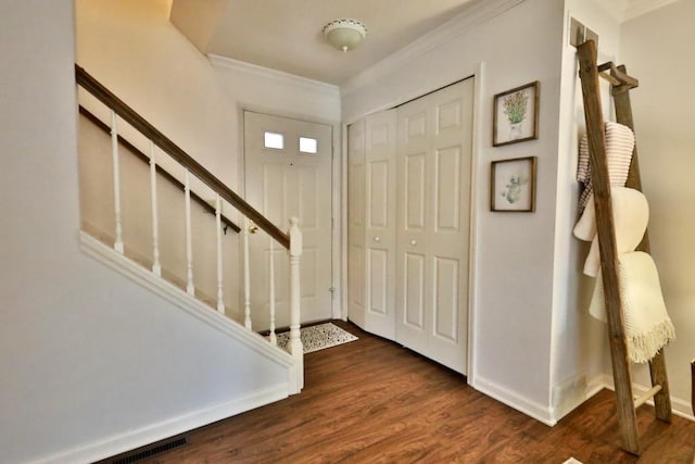 foyer entrance featuring ornamental molding and dark hardwood / wood-style flooring