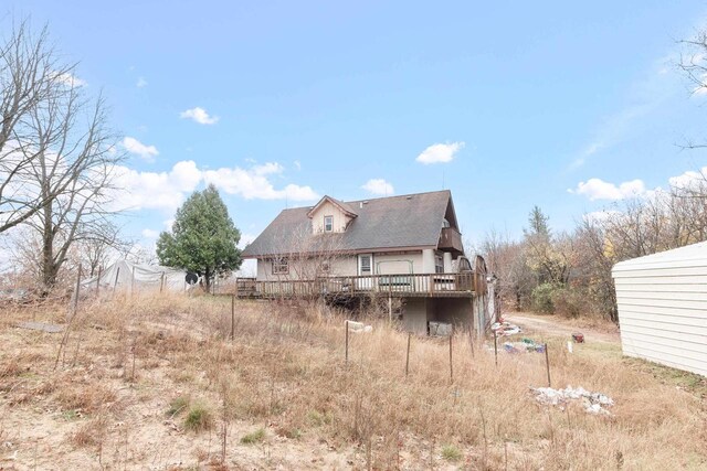 rear view of property featuring a deck