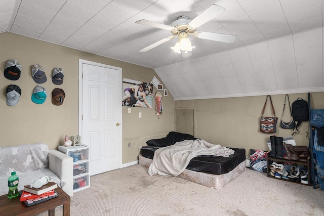 carpeted bedroom with ceiling fan and vaulted ceiling