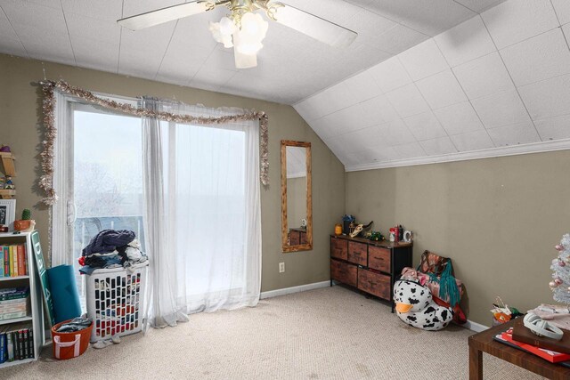 interior space with carpet flooring, ceiling fan, and vaulted ceiling