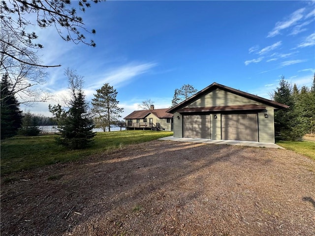 exterior space featuring a deck, an outdoor structure, and a garage