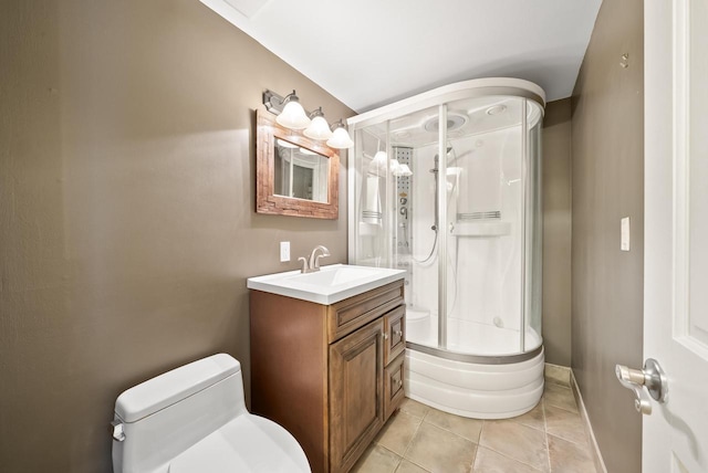 bathroom with toilet, vanity, and tile patterned floors