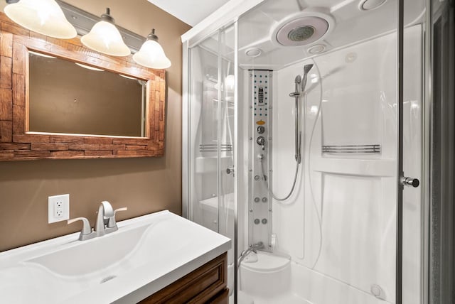 bathroom with vanity and a shower with shower door