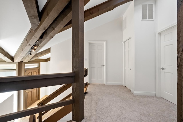 hall featuring light carpet, beamed ceiling, and high vaulted ceiling