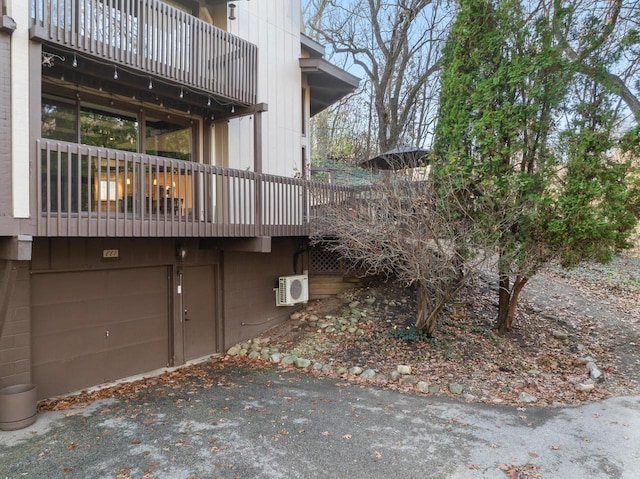 view of home's exterior featuring ac unit and a garage