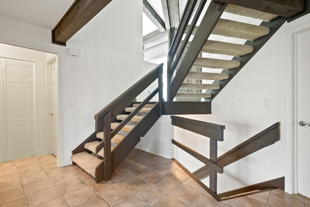 staircase with tile patterned flooring and a wealth of natural light