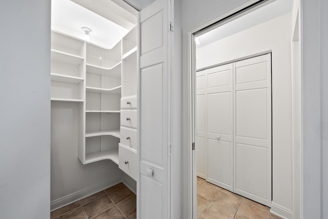 walk in closet featuring light tile patterned floors