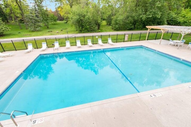 view of swimming pool with a lawn, a patio area, and a pergola