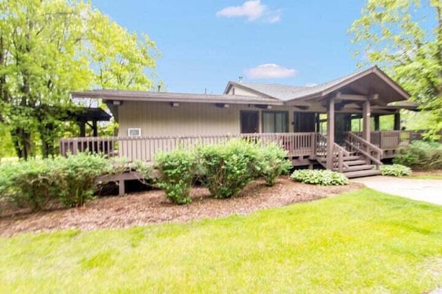 ranch-style home with a deck and a front yard