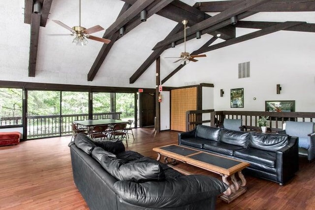 living room with beam ceiling, ceiling fan, hardwood / wood-style floors, and high vaulted ceiling