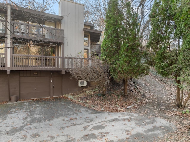 exterior space with ac unit and a garage