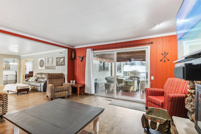 living room with wood-type flooring and crown molding