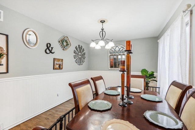 dining area with a chandelier and hardwood / wood-style flooring