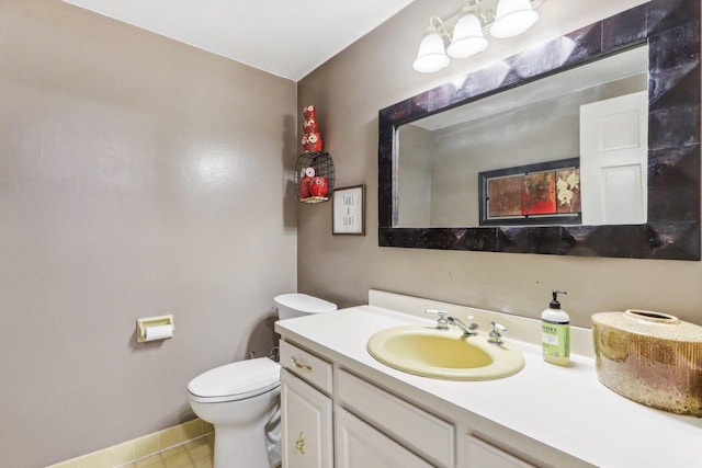 bathroom featuring tile patterned flooring, vanity, and toilet