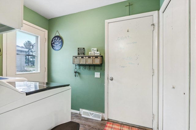 entryway featuring dark hardwood / wood-style floors and washer / dryer