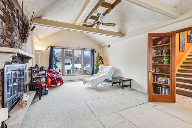 playroom featuring carpet, a textured ceiling, vaulted ceiling with beams, and ceiling fan