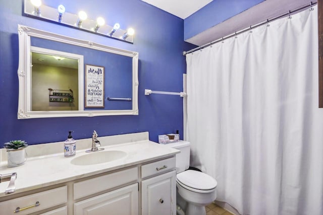 bathroom featuring tile patterned flooring, vanity, and toilet