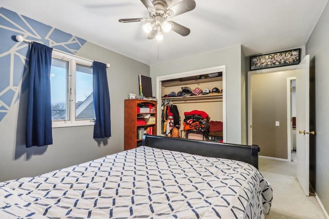 bedroom with a closet, ceiling fan, and light colored carpet