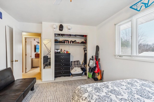 carpeted bedroom with a closet and ceiling fan