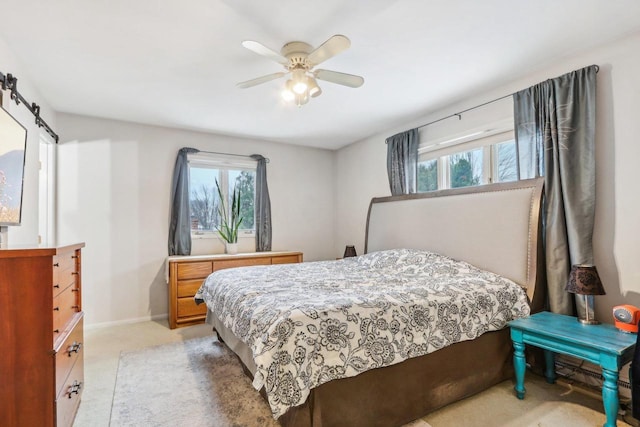 bedroom with ceiling fan and light carpet