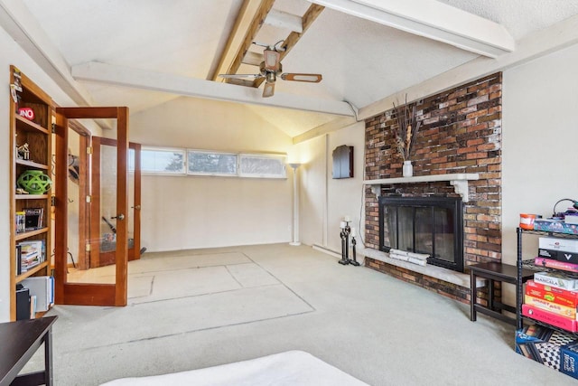 living room featuring carpet flooring, vaulted ceiling with beams, ceiling fan, and a fireplace