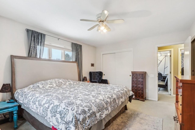 bedroom featuring ceiling fan, light colored carpet, and a closet