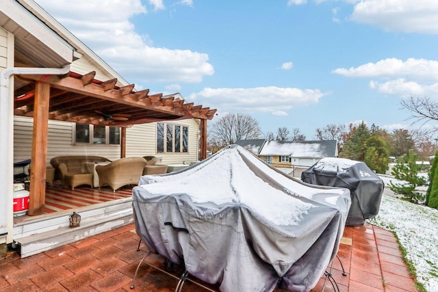 view of patio with area for grilling and a pergola