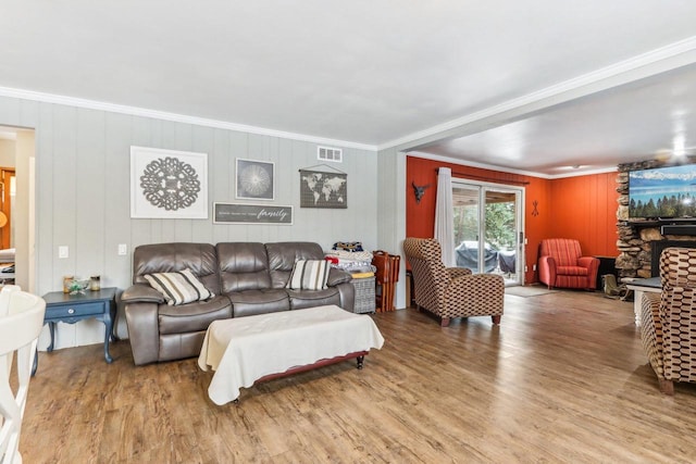 living room featuring wood-type flooring and ornamental molding