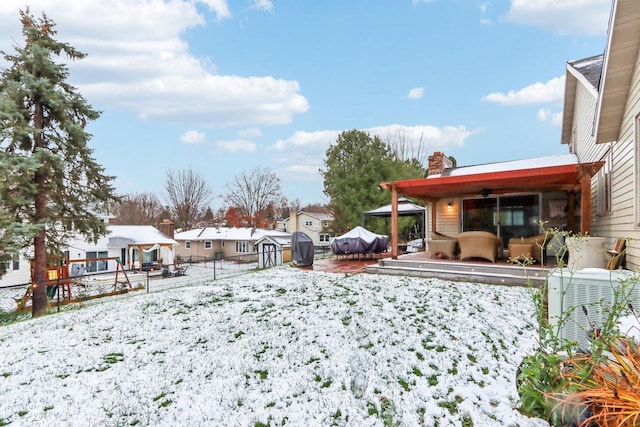 yard covered in snow with central AC