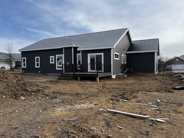 back of property featuring central AC unit and a wooden deck