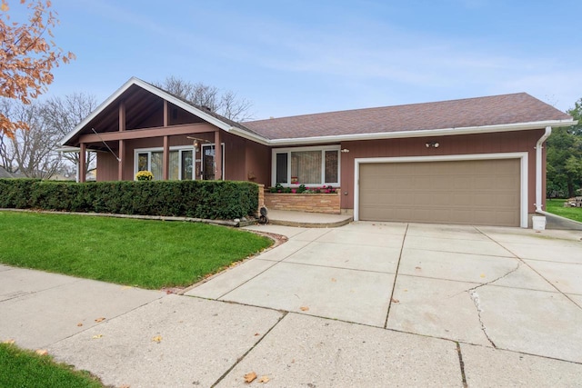 single story home featuring a front lawn and a garage