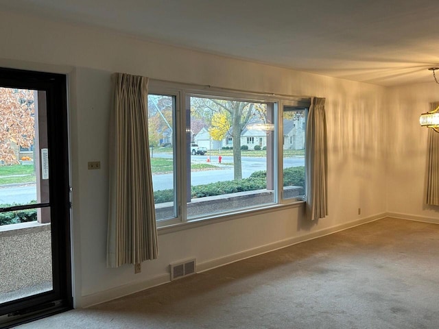 interior space featuring a healthy amount of sunlight and an inviting chandelier