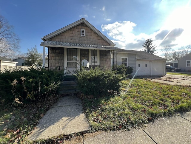 bungalow-style home with covered porch and a garage