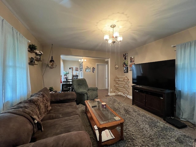 living room featuring a notable chandelier and carpet floors