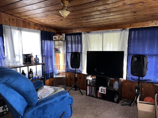 living room featuring carpet, wooden ceiling, and wood walls