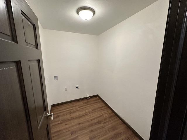 laundry area featuring electric dryer hookup and dark hardwood / wood-style floors