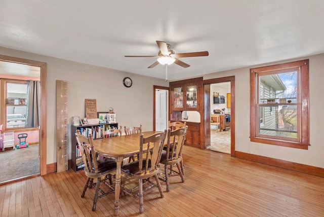 dining area featuring ceiling fan and light wood-type flooring