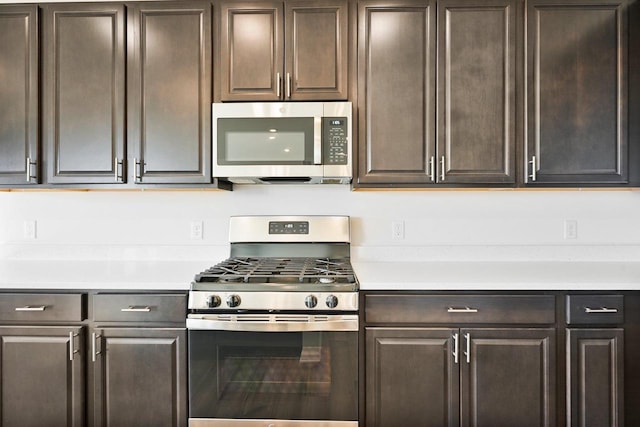 kitchen with stainless steel appliances and dark brown cabinets