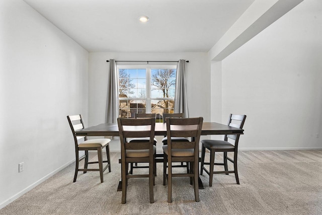 dining space featuring light colored carpet