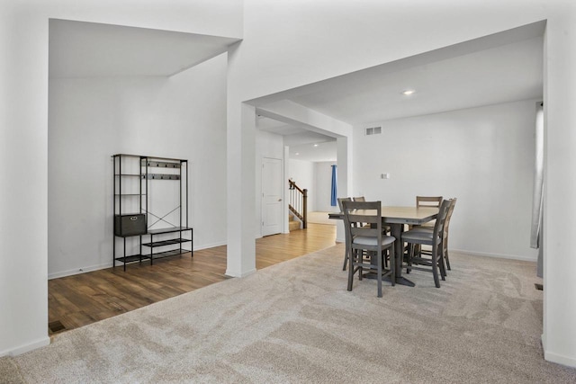 dining area with dark colored carpet