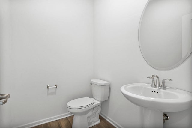 bathroom featuring sink, hardwood / wood-style flooring, and toilet