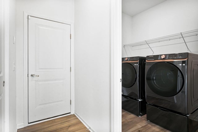 laundry room with hardwood / wood-style flooring and independent washer and dryer