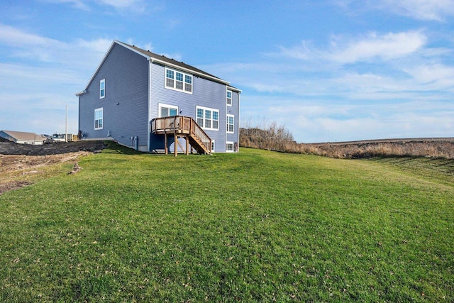 rear view of property with a deck and a lawn