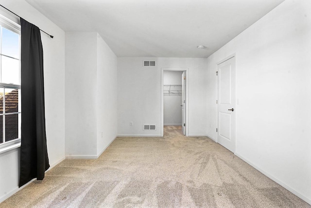 unfurnished room with light colored carpet